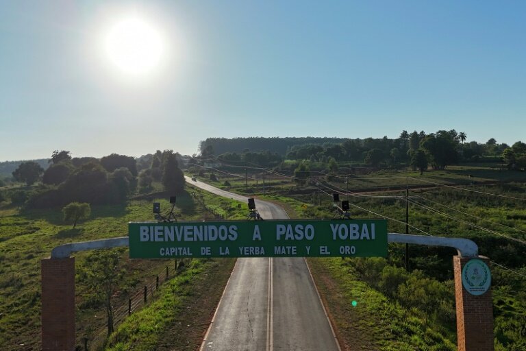Panneau d'entrée de "Bienvenue à Paso Yobai, la capitale de l'herbe à maté et de l'or", dans le département de Guaira, au Paraguay, le 11 février 2025 © Daniel DUARTE