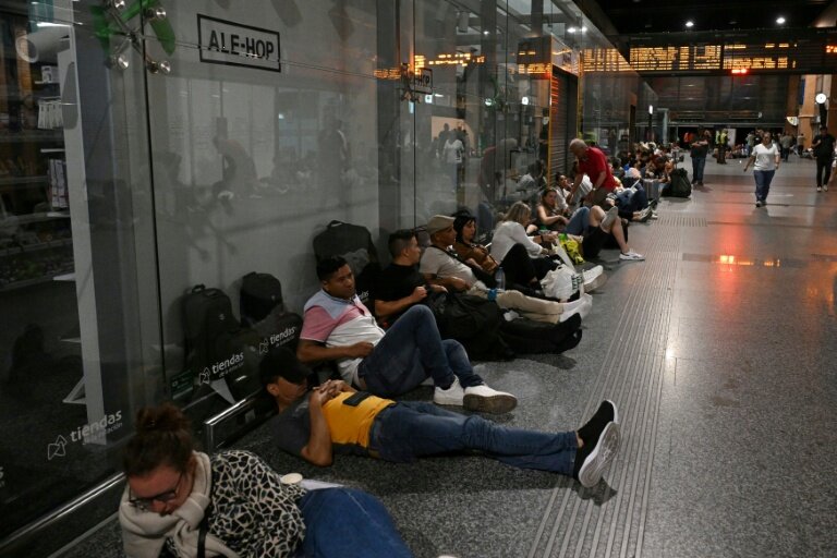 Des voyageurs sont assis ou allongés au sol alors qu'ils se préparent à passer la nuit dans la gare de Cordoue en raison d'une méga-panne électrique affectant l'Espagne et le Portugal le 28 avril 2025 © JAVIER SORIANO