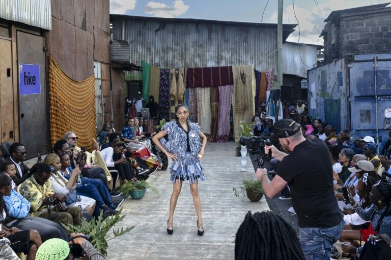 Des mannequins présentent des tenues de créateurs locaux spécialisés dans le recyclage de tissus et de vêtements mis au rebut, lors du défilé de mode Gikomba Runway Edition à Nairobi, le 10 octobre 2025 au Kenya © Tony KARUMBA