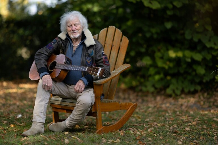Le chanteur Hugues Aufray, 96 ans, joue de la guitare dans le jardin de sa maison à Marly-le-Roi, dans les Yvelines, le 14 octobre 2025 © JOEL SAGET