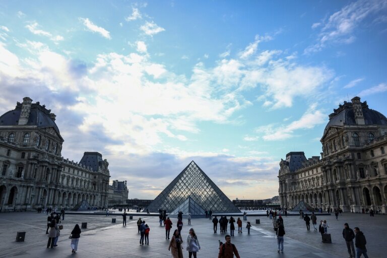 Des touristes près de la pyramide du Louvre, conçue par l'architecte sino-américain Ieoh Ming Pei, le 28 février 2025 © Behrouz MEHRI
