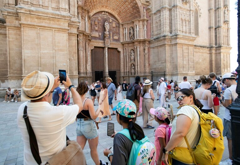 Des touristes visitent la cathédrale de Palma de Majorque, le 1er août 2025 aux Baléares, en Espagne © JAIME REINA