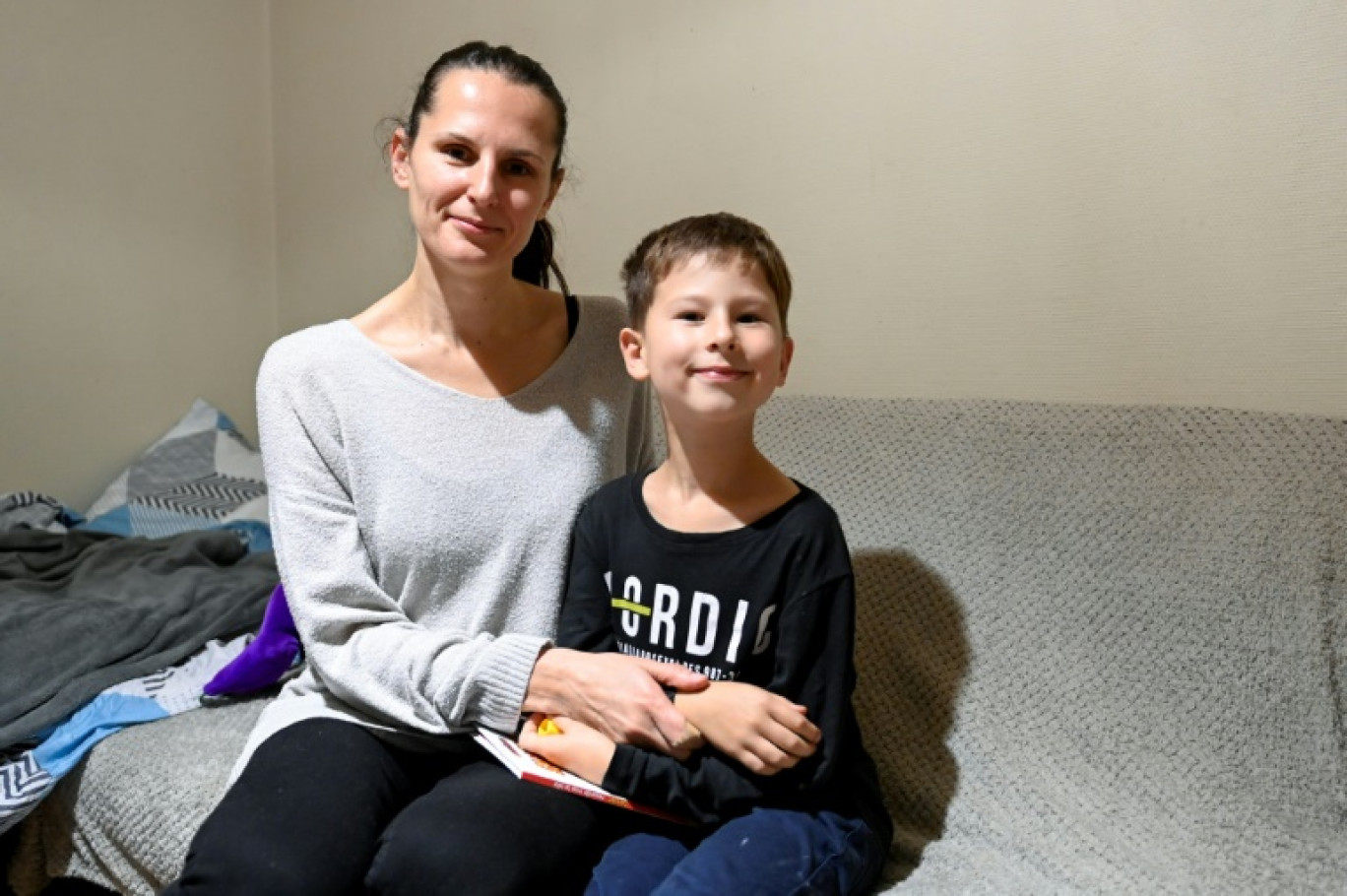 Iryna Baranovska avec son fils Roman, dans leur appartement à Jarville, en Meurthe-et-Moselle, le 21 octobre 2024 © Jean-Christophe VERHAEGEN