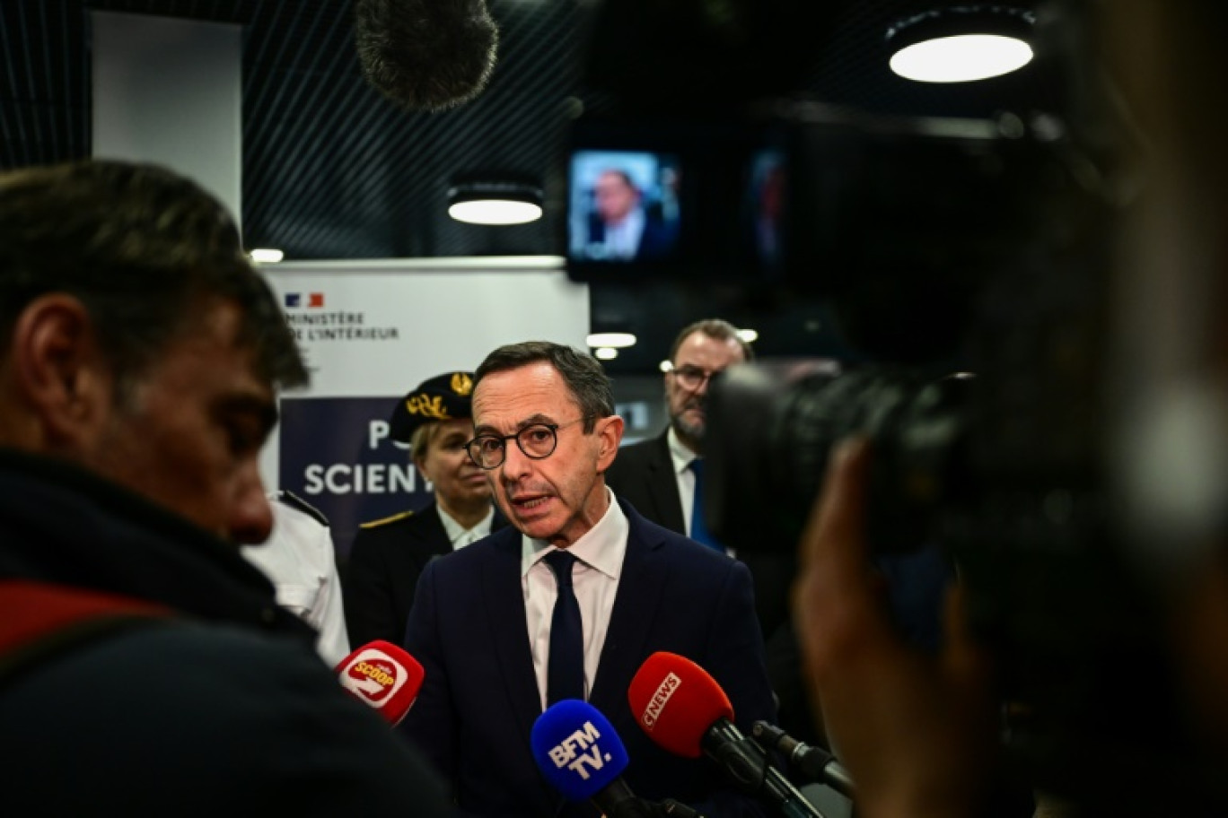 Le ministre de l'Intérieur Bruno Retailleau (c) fait une déclaration à la presse lors de sa visite à Ecully, près de Lyon, pour l'inauguration de l'école nationale de police scientifique, le 14 mars 2025 dans le Rhône © OLIVIER CHASSIGNOLE