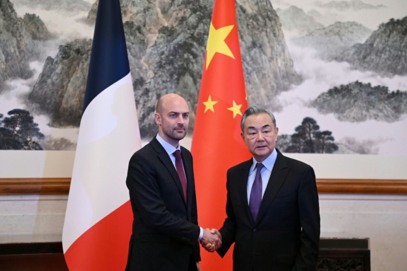 Le ministre français des Affaires étrangères Jean-Noël Barrot (à gauche) accueilli par son homologue chinois Wang Yi (à droite) à la résidence Diaoyutai à Pékin, le 27 mars 2025 © Gregory BAKER
