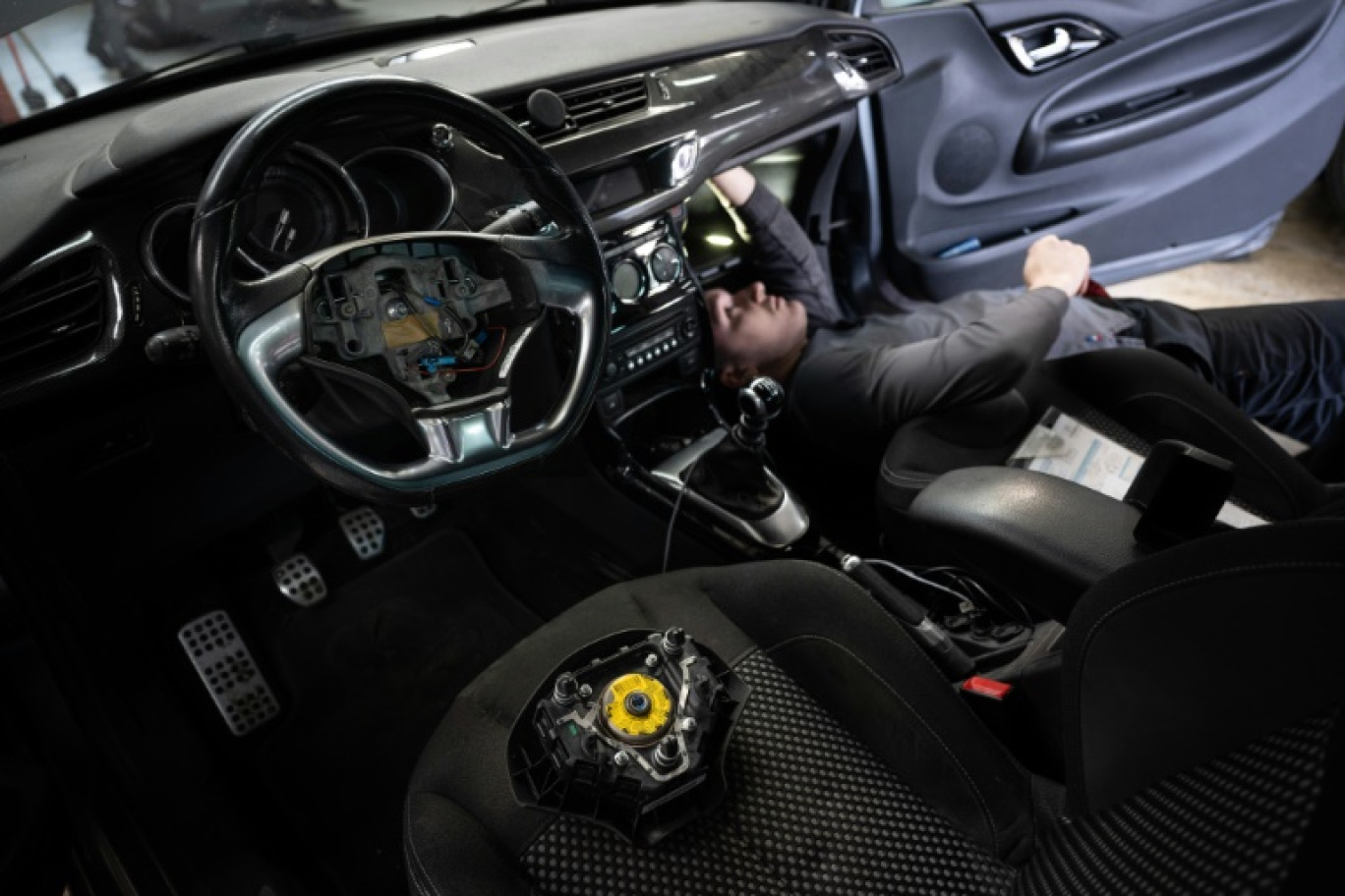 Un mécanicien remplace l'airbag d'une voiture dans un garage de Mulhouse, dans le Bas-Rhin, le 19 février 2025 © SEBASTIEN BOZON