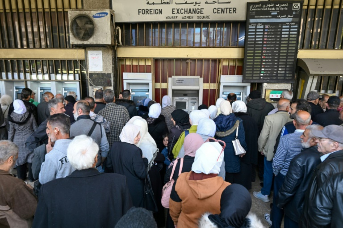 Des personnes font la queue devant des distributeurs automatiques de billets à Damas, le 16 avril 2025 en Syrie © LOUAI BESHARA