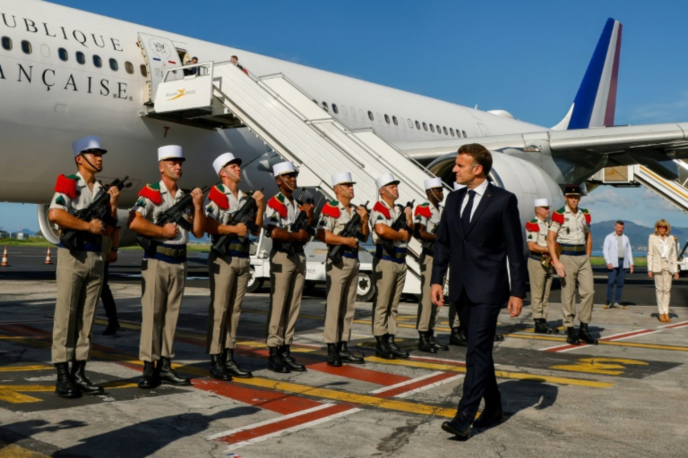 Un agent de l'ARS (g) présente des pièges à moustiques dans le cadre de la lutte contre la pandémie de chikungunya en présence du président Emmanuel Macron (d) et du ministre en charge de la santé et de l'accès aux soins Yannick Neuder (c) à Saint-Benoit, sur l'île de La Réunion, le 22 avril 2025 © Ludovic MARIN