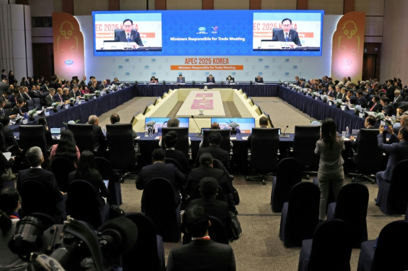 Le ministre sud-coréen du commerce Cheong In-kyo (à l'écran) fait un discours lors de l'ouverture de l'APEC à Jeju en Corée du sud le 15 mai 2025 © -