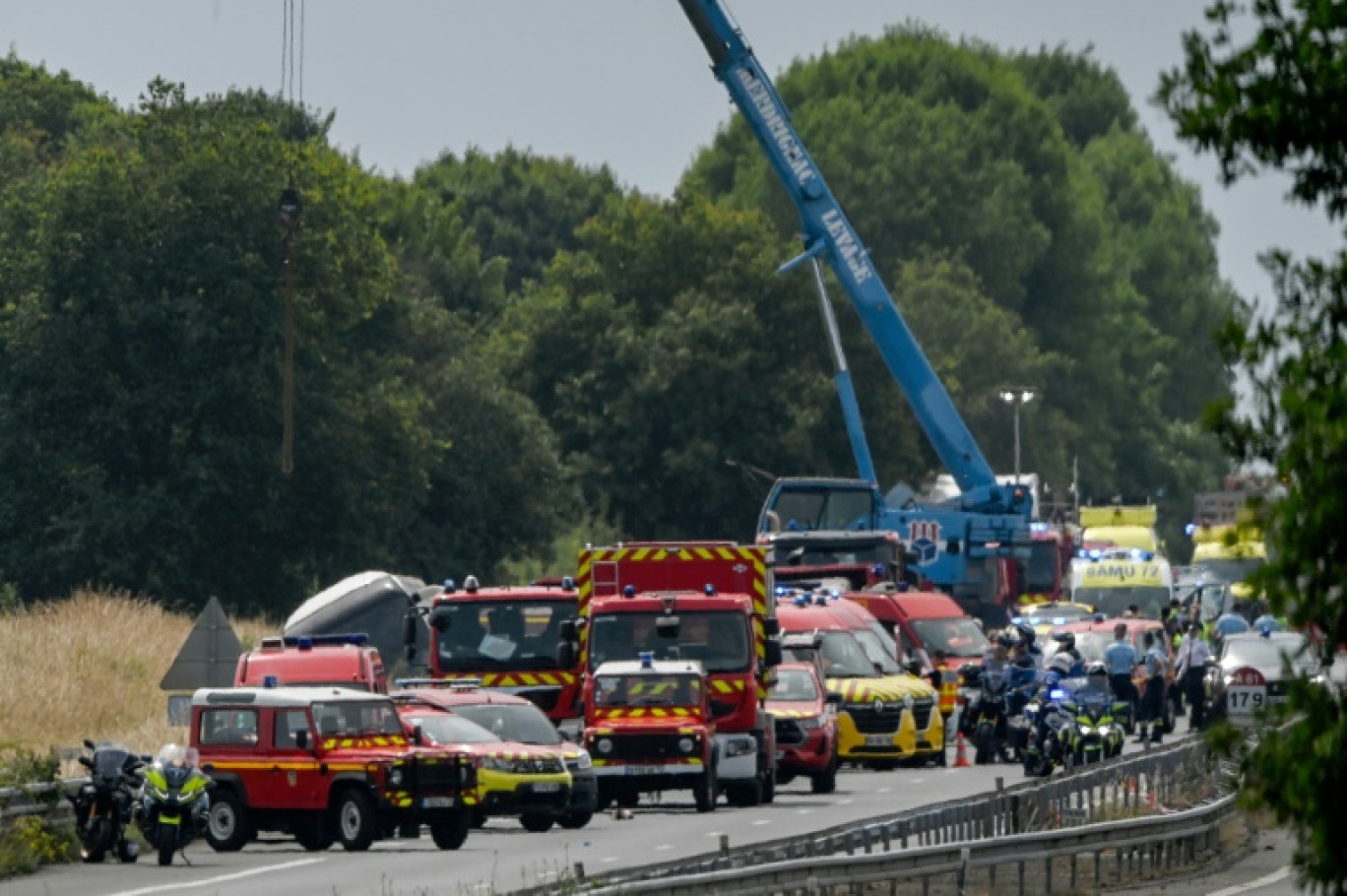 Une grue soulève un autocar accidenté sur l'autoroute A81, à Degré, dans la Sarthe, le 13 juin 2025 © JEAN-FRANCOIS MONIER